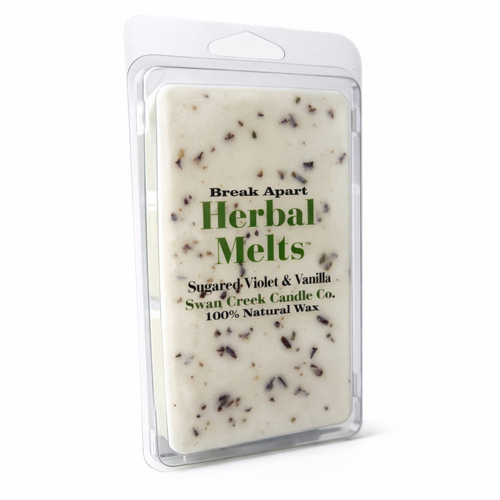 Herbal Melts wax bar with visible ingredients in a clear packaging on a white background